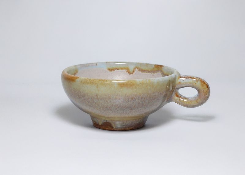 Glazed cup with a loop handle, side view