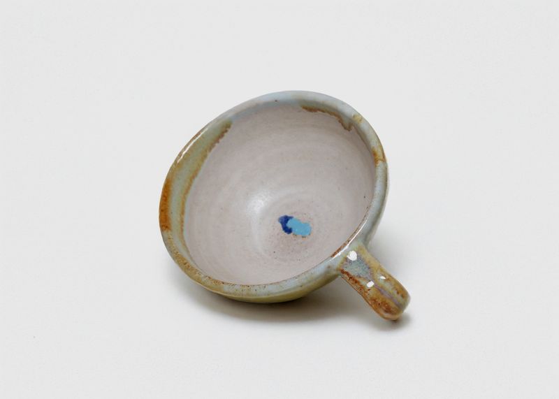 Glazed cup from above, with a blue drip inside