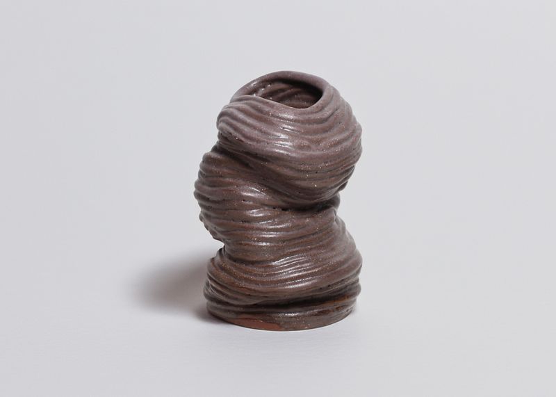Hand-built coiled vase in purple-brown clay