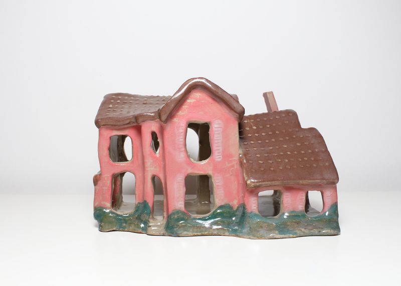 Pink ceramic house with a brown dotted roof, front