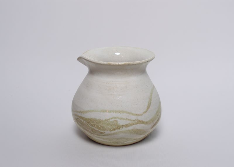 White jar with a pouring lip and swirled clay
